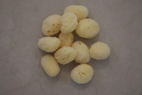 Natural sea sponge used for gentle exfoliation and cleansing featuring a soft texture arranged on a neutral background perfect for skincare and bathing routines.